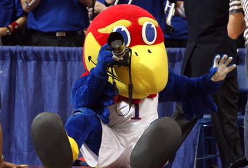 MINNEAPOLIS - MARCH 22:  Jayhawk, the mascot for the Kansas Jayhawks takes pictures with a camera from the photographer row against the Dayton Flyers during the second round of the NCAA Division I Men's Basketball Tournament at the Hubert H. Humphrey Metrodome on March 22, 2009 in Minneapolis, Minnesota.  (Photo by Jonathan Daniel/Getty Images)