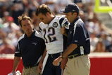 FOXBORO, MA - SEPTEMBER 7:  Quarterback Tom Brady #12 of the New England Patriots is helped off the field by trainers after he sustained an injury to his left knee in the first quarter against the Kansas City Chiefs at Gillette Stadium September 7, 2008 in Foxboro, Massachusetts.  (Photo by Elsa/Getty Images)