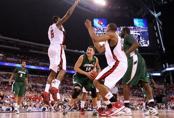 INDIANAPOLIS - MARCH 29:  Goran Suton #14 of the Michigan State Spartans looks to go up for a shot attempt against Earl Clark #5 and Samardo Samuels #24 of the Louisville Cardinals  during the fourth round of the NCAA Division I Men's Basketball Tournament at the Lucas Oil Stadium on March 29, 2009 in Indianapolis, Indiana.  (Photo by Andy Lyons/Getty Images)
