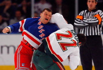 NEW YORK - MARCH 24:  Cal Clutterbuck #22 of the Minnesota Wild fights Sean Avery #16 of the New York Rangers during the first period on March 24, 2009 at Madison Square Garden in New York City.  (Photo by Jim McIsaac/Getty Images)