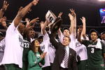 INDIANAPOLIS - MARCH 29:  Head coach Tom Izzo of the Michigan State Spartans and his wife, Lupe, celebrate with the Michigan State players after they were presented with the midwest region trophy following their 64-52 win against the Louisville Cardinals during the fourth round of the NCAA Division I Men's Basketball Tournament at the Lucas Oil Stadium on March 29, 2009 in Indianapolis, Indiana.  (Photo by Andy Lyons/Getty Images)