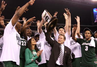 INDIANAPOLIS - MARCH 29:  Head coach Tom Izzo of the Michigan State Spartans and his wife, Lupe, celebrate with the Michigan State players after they were presented with the midwest region trophy following their 64-52 win against the Louisville Cardinals during the fourth round of the NCAA Division I Men's Basketball Tournament at the Lucas Oil Stadium on March 29, 2009 in Indianapolis, Indiana.  (Photo by Andy Lyons/Getty Images)