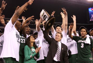 INDIANAPOLIS - MARCH 29:  Head coach Tom Izzo of the Michigan State Spartans and his wife, Lupe, celebrate with the Michigan State players after they were presented with the midwest region trophy following their 64-52 win against the Louisville Cardinals during the fourth round of the NCAA Division I Men's Basketball Tournament at the Lucas Oil Stadium on March 29, 2009 in Indianapolis, Indiana.  (Photo by Andy Lyons/Getty Images)