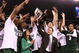 INDIANAPOLIS - MARCH 29: Head coach Tom Izzo of the Michigan State Spartans and his wife, Lupe, celebrate with the Michigan State players after they were presented with the midwest region trophy following their 64-52 win against the Louisville Cardinals during the fourth round of the NCAA Division I Men's Basketball Tournament at the Lucas Oil Stadium on March 29, 2009 in Indianapolis, Indiana. (Photo by Andy Lyons/Getty Images)