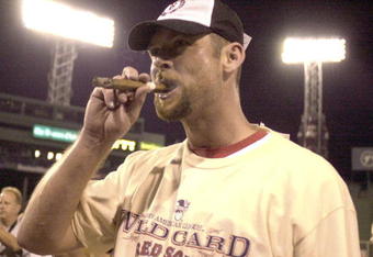BOSTON - SEPTEMBER 25: David McCarty #10 of the Boston Red Sox celebrates with a cigar after beating the Baltimore Orioles to clinch the AL wildcard spot September 26, 2003 at Fenway Park in Boston, Massachusetts. (Photo by John Mottern/Getty Images)