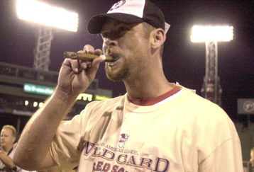 BOSTON - SEPTEMBER 25: David McCarty #10 of the Boston Red Sox celebrates with a cigar after beating the Baltimore Orioles to clinch the AL wildcard spot September 26, 2003 at Fenway Park in Boston, Massachusetts. (Photo by John Mottern/Getty Images)