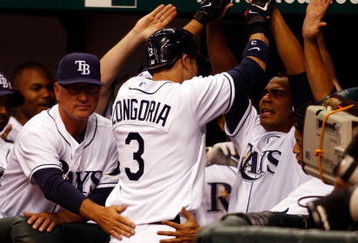 ST. PETERSBURG, FL - APRIL 14: Infielder Evan Longoria #3 of the Tampa Bay Rays is congratulated by his teammates after his seventh inning home run tied the game against the New York Yankees on April 14, 2008 at Tropicana Field in St. Petersburg, Florida. (Photo by J. Meric/Getty Images)