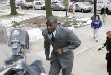 LEBANON - JANUARY 14: New York Giants wide receiver Plaxico Burress runs up the front steps toward members of the media as he arrives at the Lebanon County Courthouse January 14, 2009 in Lebanon, Pa.  Burress is scheduled to appear in a civil trial in a dispute with an automobile dealer over what he owes in damages to a vehicle supplied to him by the dealership. (Photo by Chris Gardner/Getty Images)