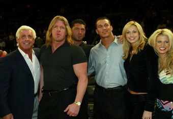 NEW YORK - MARCH 9:  WWE wrestlers (L-R) Ric Flair, Triple H, Batista, Randy Orton, Stacy Kiebler & Miss Jackie attend the New York Knicks v Boston Celtics  NBA game March 9, 2004 at Madison Square Garden in New York City.   (Photo by Ray Amati/Getty Images)