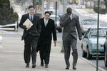 LEBANON - JANUARY 14: New York Giants wide receiver Plaxico Burress, right, walks with members of his legal team as he arrives at the Lebanon County Courthouse January 14, 2009 in Lebanon, Pa.  Burress is scheduled to appear in a civil trial in a dispute with an automobile dealer over what he owes in damages to a vehicle supplied to him by the dealership. (Photo by Chris Gardner/Getty Images)