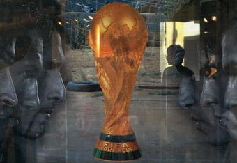 BEIJING, CHINA - JUNE 5: (CHINA OUT) An attendant is seen through a show window featuring football stars and the World Cup trophy at an adidas shop on June 5, 2006 in Beijing, China. Billboards and decorations featuring imagery relating to the World Cup, which starts June 9 in Germany, are being displayed on many Beijing streets as the event is seen as a great opportunity for local businesses, according to local media. (Photo by China Photos/Getty Images)