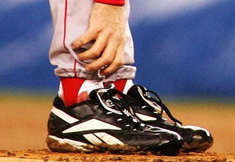 NEW YORK - OCTOBER 19:   Pitcher Curt Schilling #38 of the Boston Red Sox grabs at his ankle as it appears to be bleeding in the fourth inning during game six of the American League Championship Series against the New York Yankees on October 19, 2004 at Yankee Stadium in the Bronx borough of New York City. (Photo by Al Bello/Getty Images)