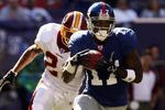 EAST RUTHERFORD, NJ - OCTOBER 08:  Plaxico Burress #17 of the New York Giants runs for a 46-yard gain in front of Sean Taylor #21 of the Washington Redskins on October 8, 2006 at Giants Stadium in East Rutherford, New Jersey.  (Photo by Nick Laham/Getty Images)