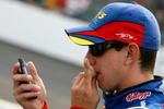 INDIANAPOLIS - JULY 28: Kyle Busch, driver of the #5 Kellogg's/CARQUEST Chevrolet, looks at his cellphone on pit road during qualifying for the NASCAR Nextel Cup Series Allstate 400 at Indianapolis Motor Speedway on July 28, 2007 in Indianapolis, Indiana.  (Photo by Kevin C. Cox/Getty Images)