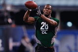 INDIANAPOLIS, IN - FEBRUARY 23:  Defensive lineman Mike Johnson of Georgia Tech catches the football during the NFL Scouting Combine presented by Under Armour at Lucas Oil Stadium on February 23, 2009 in Indianapolis, Indiana. (Photo by Scott Boehm/Getty Images)
