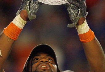 MIAMI - JANUARY 08:  Brandon Spikes #51 of the Florida Gators holds up the winning trophy after the FedEx BCS National Championship Game against the Oklahoma Sooners at Dolphin Stadium on January 8, 2009 in Miami, Florida.  (Photo by Eliot J. Schechter/Getty Images)