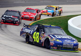 MARTINSVILLE, VA - MARCH 29:  Jimmie Johnson, driver of the #48 Lowe's Chevrolet, leads Denny Hamlin, driver of the #11 FedEx Express Toyota, Tony Stewart, driver of the #14 Office Depot Chevrolet, and Kyle Busch, driver of the #18 M&M's Toyota, late in the NASCAR Sprint Cup Series Goody's Fast Pain Relief 500 at the Martinsville Speedway on March 29, 2009 in Martinsville, Virginia.  (Photo by Jim McIsaac/Getty Images)
