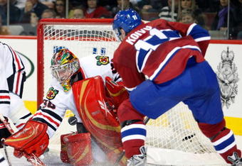 MONTREAL- MARCH 31:  Cristobal Huet #38 of the Chicago Blackhawks stops the puck on a shot by Saku Koivu #11 of the Montreal Canadiens during the NHL game at the Bell Centre March 31, 2009 in Montreal, Quebec, Canada.  (Photo by Richard Wolowicz/Getty Images)