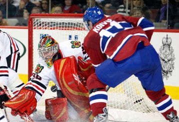 MONTREAL- MARCH 31:  Cristobal Huet #38 of the Chicago Blackhawks stops the puck on a shot by Saku Koivu #11 of the Montreal Canadiens during the NHL game at the Bell Centre March 31, 2009 in Montreal, Quebec, Canada.  (Photo by Richard Wolowicz/Getty Images)