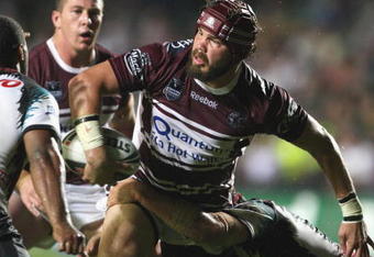 SYDNEY, AUSTRALIA - MARCH 30:  Adam Cuthbertson  of the Sea Eagles gets a pass away as he is tackled during the round three NRL match between the Manly Warringah Sea Eagles and the Penrith Panthers at Brookvale Oval on March 30, 2009 in Sydney, Australia.  (Photo by Mark Kolbe/Getty Images)