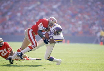 SAN FRANCISCO - OCTOBER 30:  Defenseman Ronnie Lott #42 of the San Francisco 49ers makes a tackle during a NFL game against the Minnesota Vikings at Candlestick Park on October 30, 1988 in San Francisco, California.  The Niners defeated the Vikings 24-21.  (Photo by Otto Greule Jr/Getty Images)
