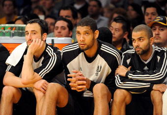 LOS ANGELES, CA - JANUARY 25:  (L-R) Manu Ginobili #20, Tim Duncan #21, and Tony Parker #9 of the San Antonio Spurs watch from the sidelines during the third quarter against the Los Angeles Lakers at the Staples Center on January 25, 2009 in Los Angeles, California.  The Lakers defeated the Spurs 99-85.  NOTE TO USER:  User expressly acknowledges and agrees that, by downloading and/or using this photograph, User is consenting to the terms and conditions of the Getty Images License Agreement.  (Photo by Harry How/Getty Images)