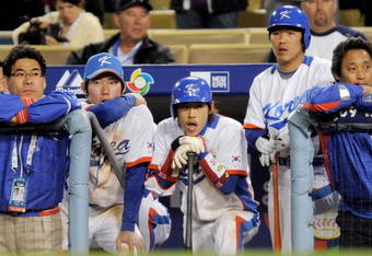 LOS ANGELES, CA - MARCH 23:  Yong-Kyu Lee #15 of Korea (C) and teammates look on from the dugout in the tenth inning of the finals of the 2009 World Baseball Classic against Japan on March 23, 2009 at Dodger Stadium in Los Angeles, California. Japan won 5-3 in 10 innings.  (Photo by Kevork Djansezian/Getty Images)