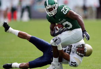 EAST LANSING, MI - SEPTEMBER 15:  Javon Ringer #23 of the Michigan State Spartans tries to  break free from Aaron Berry #17 of the Pittsburgh Panthers during the fourth quarter at Spartan Stadium on September 15, 2007 in East Lansing, Michigan. The Spartans defeated the Panthers 17-13.  (Photo by Harry How/Getty Images)