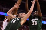 INDIANAPOLIS - MARCH 29:  Goran Suton #14 and Draymond Green #23 of the Michigan State Spartans reach for a rebound against Samardo Samuels #24 of the Louisville Cardinals during the fourth round of the NCAA Division I Men's Basketball Tournament at the Lucas Oil Stadium on March 29, 2009 in Indianapolis, Indiana.  (Photo by Andy Lyons/Getty Images)