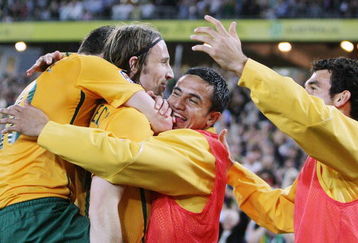 SYDNEY, AUSTRALIA - APRIL 01: Harry Kewell (L) and Tim Cahill (2nd R) of Australia embrace Joshua Kennedy (2nd L) after Kennedy scored a goal during the 2010 FIFA World Cup qualifying match between the Australian Socceroos and Uzbekistan at ANZ Stadium on April 1, 2009 in Sydney, Australia.  (Photo by Mark Nolan/Getty Images)