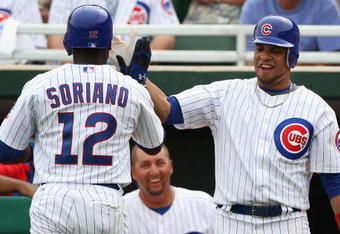MESA, AZ - MARCH 03:  Aramis Ramirez #16 of the Chicago Cubs congratulates teammate Alfonso Soriano #12 after Soriano hit a solo home run against the Oakland Athletics during the first inning of the spring training game at HoHoKam Park on March 3, 2009 in Mesa, Arizona. The Cubs defeated the A's 6-4.  (Photo by Christian Petersen/Getty Images)