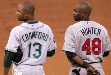 SAN FRANCISCO - JULY 10:  American League All-Stars Carl Crawford #13 of the Tampa Bay Devil Rays and Torii Hunter #48 of the Minnesota Twins stand attended during the singing of 'God Bless America' in the 78th Major League Baseball All-Star Game at AT&T Park on July 10, 2007 in San Francisco, California.  (Photo by Justin Sullivan/Getty Images)