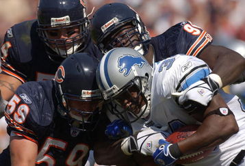 CHICAGO - SEPTEMBER 12: Joe Odom #59, Brian urlacher #54 and Alex brown # 96 of the Chicago Bears combine to tackle Kevin Jones #34 of the Detroit Lions during a game on September 12, 2004 at Soldier Field in Chicago, Illinois. The Lions defeated the Bears 20-16. (Photo by Jonathan Daniel/Getty Images)