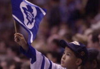 3 May 2001: A Toronto Maple Leafs fan waves a Leaf flag during game 4 of the Eastern Conference Semifinals against the New Jersey Devils at the Air Canada Center in Toronto, Ontario, Canada. The Leafs won 3-1. DIGITAL IMAGE. Mandatory Credit: Harry How/ALLSPORT