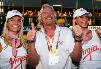 MELBOURNE, AUSTRALIA - MARCH 29:  Sir Richard Branson celebrates as Jenson Button of Great Britain and Brawn GP wins the Australian Formula One Grand Prix at the Albert Park Circuit on March 29, 2009 in Melbourne, Australia.  (Photo by Clive Mason/Getty Images)
