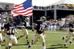 ANNAPOLIS, MD - SEPTEMBER 20: Safety Jeff Deliz #17 of the Navy Midshipmen carries the American Flag to the field before play against the Rutgers Scarlet Knights at Jack Stephens Field at Navy-Marine Corps Memorial Stadium on September 20, 2008 in Annapolis, Maryland.  (Photo by Al Messerschmidt/Getty Images)