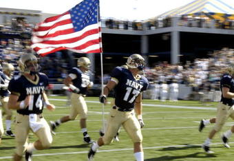 ANNAPOLIS, MD - SEPTEMBER 20: Safety Jeff Deliz #17 of the Navy Midshipmen carries the American Flag to the field before play against the Rutgers Scarlet Knights at Jack Stephens Field at Navy-Marine Corps Memorial Stadium on September 20, 2008 in Annapolis, Maryland.  (Photo by Al Messerschmidt/Getty Images)