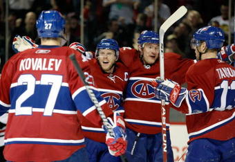 MONTREAL- MARCH 31:  Saku Koivu #11 of the Montreal Canadiens celebrates his second period goal with teammates Andrei Markov #79, Alexei Kovalev #27 and Alex Tanguay #13 during the NHL game against the Chicago Blackhawks at the Bell Centre March 31, 2009 in Montreal, Quebec, Canada.  (Photo by Richard Wolowicz/Getty Images)
