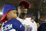 GLENDALE, AZ - FEBRUARY 03:  Plaxico Burress #17 of the New York Giants celebrates with his son Elijah Burress after the Giants defeated the New England Patriots 17-14 during Super Bowl XLII on February 3, 2008 at the University of Phoenix Stadium in Glendale, Arizona.  (Photo by Donald Miralle/Getty Images)
