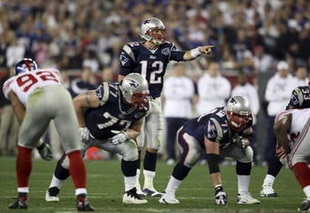 GLENDALE, AZ - FEBRUARY 03:  Quarterback Tom Brady #12 of the New England Patriots directs the offense at the line of scrimmage against the New York Giants during Super Bowl XLII on February 3, 2008 at the University of Phoenix Stadium in Glendale, Arizona.  (Photo by Andy Lyons/Getty Images)