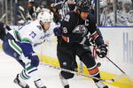 EDMONTON, AB - SEPTEMBER 22:  Alexander Edler #23 of the Vancouver Canucks poke checks the puck from the stick of Ethan Moreau #18 of the Edmonton Oilers during an NHL preseason game on September 22, 2008 at Rexall Arena in Edmonton, Canada. The Canucks defeated the Oilers 4-3 in shootout overtime. (Photo by Jimmy Jeong/Getty Images)