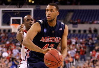 INDIANAPOLIS - MARCH 27:  Jamelle Horne #42 of the Arizona Wildcats looks to pass the ball against Andre McGee #33 of the Louisville Cardinals  during the third round of the NCAA Division I Men's Basketball Tournament at the Lucas Oil Stadium on March 27, 2009 in Indianapolis, Indiana. Louisville won 103-64.  (Photo by Andy Lyons/Getty Images)