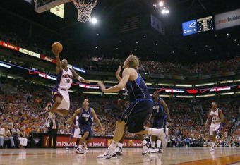 PHOENIX - JUNE 03:  Leandro Barbosa #10 of the Phoenix Suns lays the ball up against Dirk Nowitzki #41 of the Dallas Mavericks in game six of the Western Conference Finals during the 2006 NBA Playoffs on June 3, 2006 at US Airways Center in Phoenix, Arizona.  NOTE TO USER: User expressly acknowledges and agrees that, by downloading and or using this photograph, User is consenting to the terms and conditions of the Getty Images License Agreement.  (Photo by Lisa Blumenfeld/Getty Images)