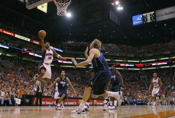 PHOENIX - JUNE 03:  Leandro Barbosa #10 of the Phoenix Suns lays the ball up against Dirk Nowitzki #41 of the Dallas Mavericks in game six of the Western Conference Finals during the 2006 NBA Playoffs on June 3, 2006 at US Airways Center in Phoenix, Arizona.  NOTE TO USER: User expressly acknowledges and agrees that, by downloading and or using this photograph, User is consenting to the terms and conditions of the Getty Images License Agreement.  (Photo by Lisa Blumenfeld/Getty Images)