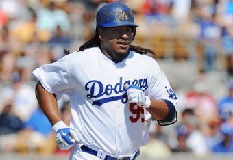 GLENDALE, AZ - MARCH 13:   Manny Ramirez #99 of the Los Angeles Dodgers runs to first base after a walk during a Spring Training game against the Texas Rangers on March 13, 2009 at Camelback Ranch in Glendale, Arizona.  (Photo by Lisa Blumenfeld/Getty Images)