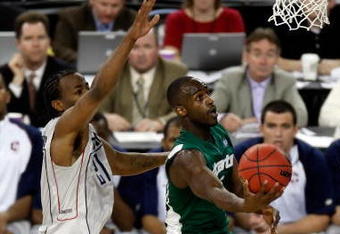 DETROIT - APRIL 04:  Travis Walton #5 of the Michigan State Spartans goes up for a shot against Stanley Robinson #21 of the Connecticut Huskies in the first half during the National Semifinal game of the NCAA Division I Men's Basketball Championship at Ford Field on April 4, 2009 in Detroit, Michigan.  (Photo by Streeter Lecka/Getty Images)