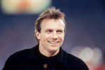 SAN FRANCISCO - DECEMBER 23:  Not dressed for the game, quarterback Joe Montana of the San Francisco 49ers, looks on during a game against the Chicago Bears at Candlestick Park on December 24, 1991 in San Francisco, California.  The 49ers won 52-14.  (Photo by George Rose/Getty Images)