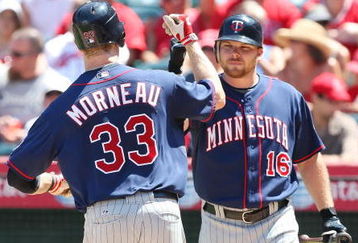 ANAHEIM, CA - AUGUST 24:   (L)Justin Morneau #33 of the Minnesota Twins is congratulated by teammate Jason Kubel #16 after hitting a homnerun in the sixth inning against the Los Angeles Angels of Anaheim at Angels Stadium on August 24, 2008 in Anaheim, California.  (Photo by Lisa Blumenfeld/Getty Images)