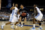 DETROIT - APRIL 04:  Scott Reynolds #1 of the Villanova Wildcats drives against Wayne Ellington #22 and Deon Thompson #21 of the North Carolina Tar Heels during the second half of the National Semifinal game of the NCAA Division I Men's Basketball Championship at Ford Field on April 4, 2009 in Detroit, Michigan. North Carolina won 83-69. (Photo by Andy Lyons/Getty Images)