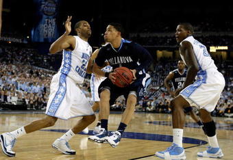 DETROIT - APRIL 04:  Scott Reynolds #1 of the Villanova Wildcats drives against Wayne Ellington #22 and Deon Thompson #21 of the North Carolina Tar Heels during the second half of the National Semifinal game of the NCAA Division I Men's Basketball Championship at Ford Field on April 4, 2009 in Detroit, Michigan. North Carolina won 83-69. (Photo by Andy Lyons/Getty Images)